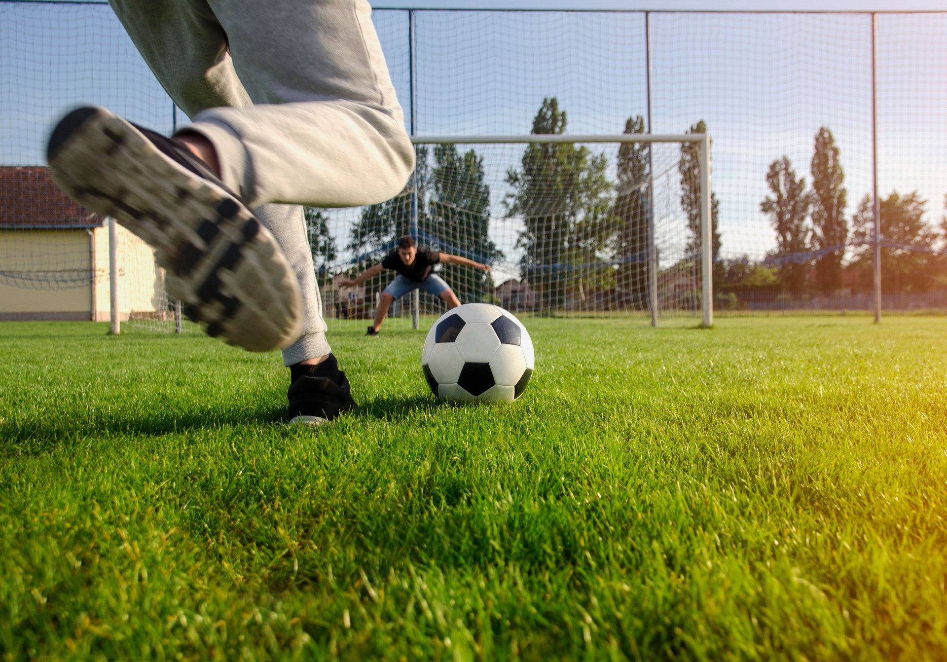 Closeup shot teen preparing to kick the ball , penalty shootout concept